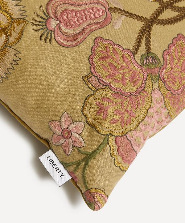 Close up of the Liberty London Lady Palampore pillow in green with pink embroidery