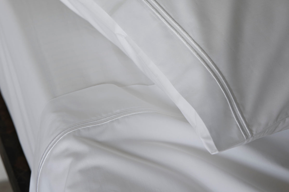 Peter Reed White Sheets on Bed
