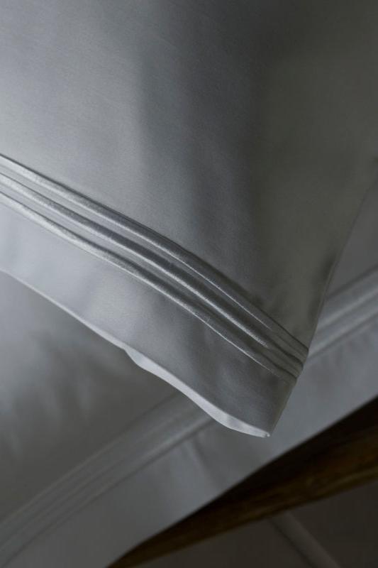 Peter Reed White Sheets on Bed
