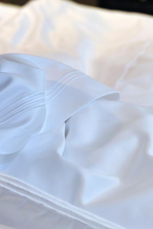 Peter Reed White Sheets on Bed