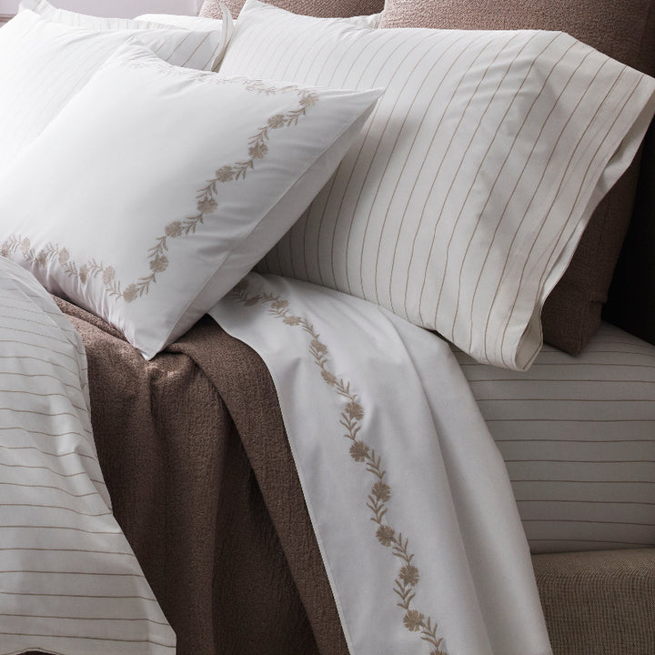 Close up of Matouk Amalfi Bedding on a luxuriously made bed