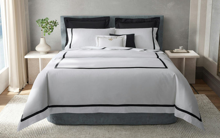 Neatly made bed with Matouk Lowell Bedding