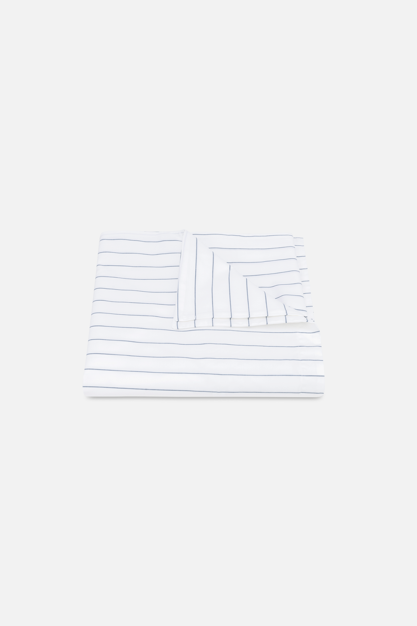 A Matouk Amalfi pinstripe duvet cover in Mediterranean blue, with a hidden zipper closure.