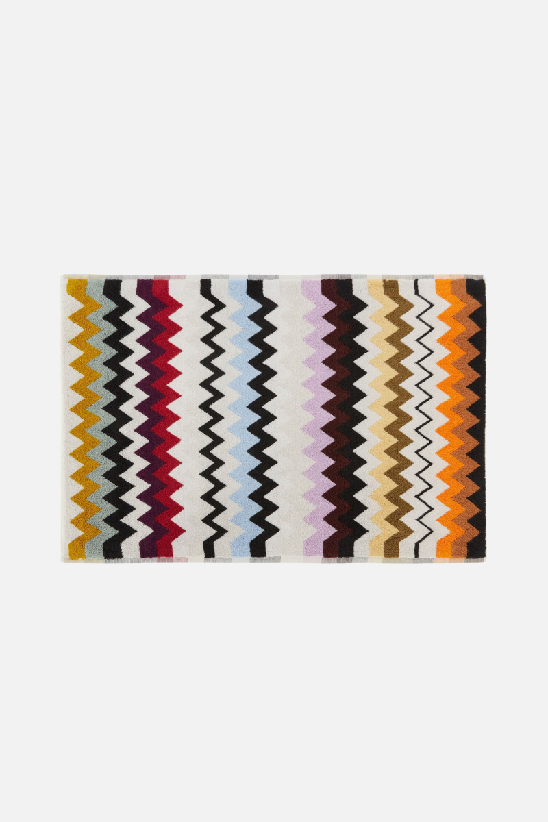 Multicolored zigzag patterned rug on a white background