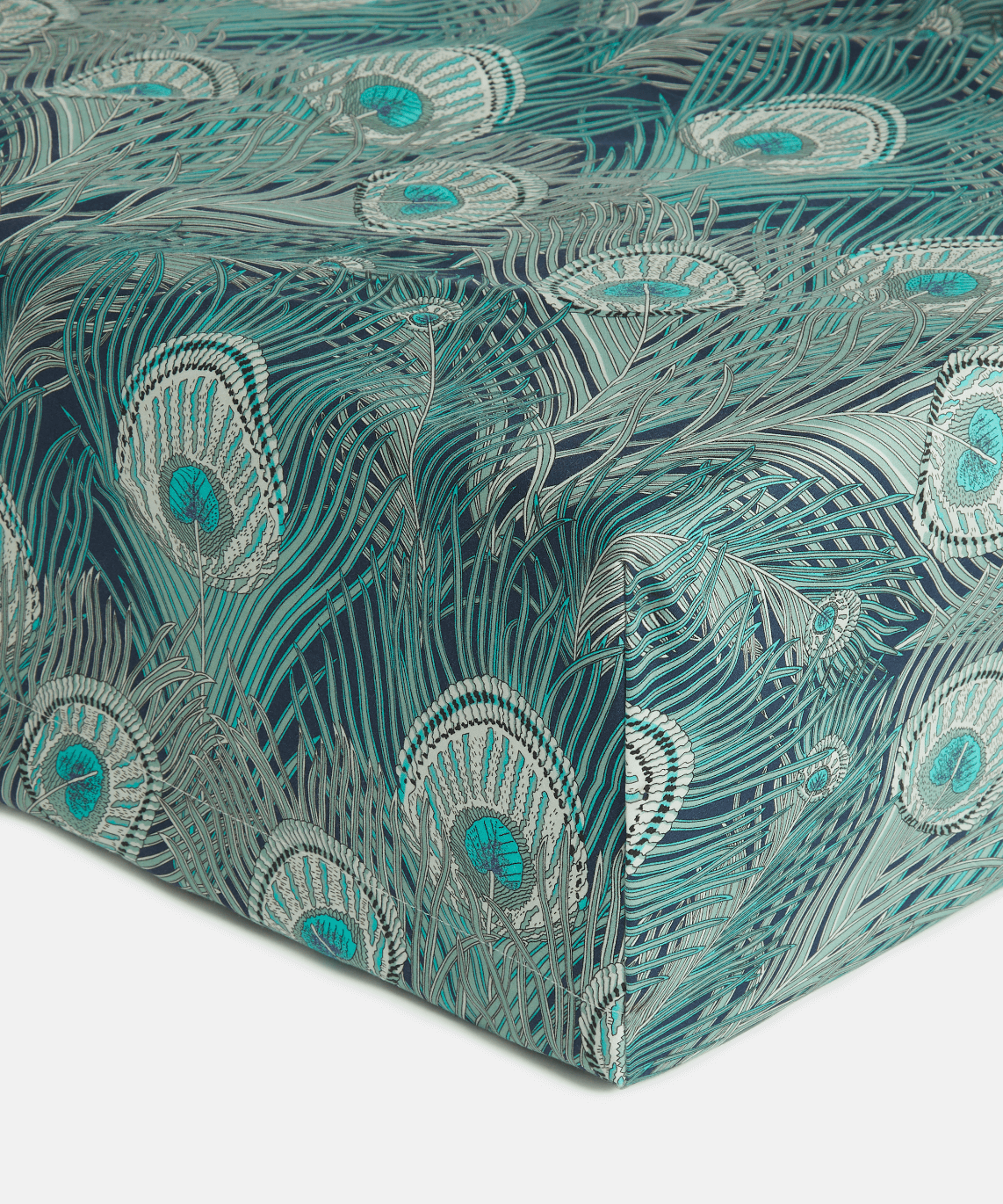Close up of the corner of the Liberty London Hera fitted sheet in Jade Peacock