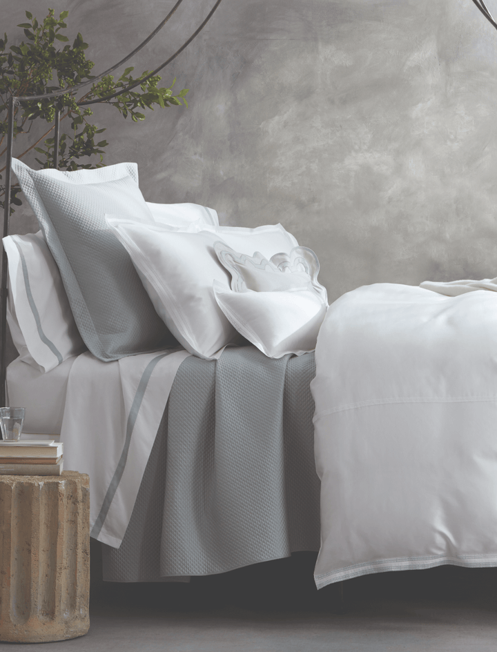 Matouk Lowell Bedding Collection on a bed in Pool