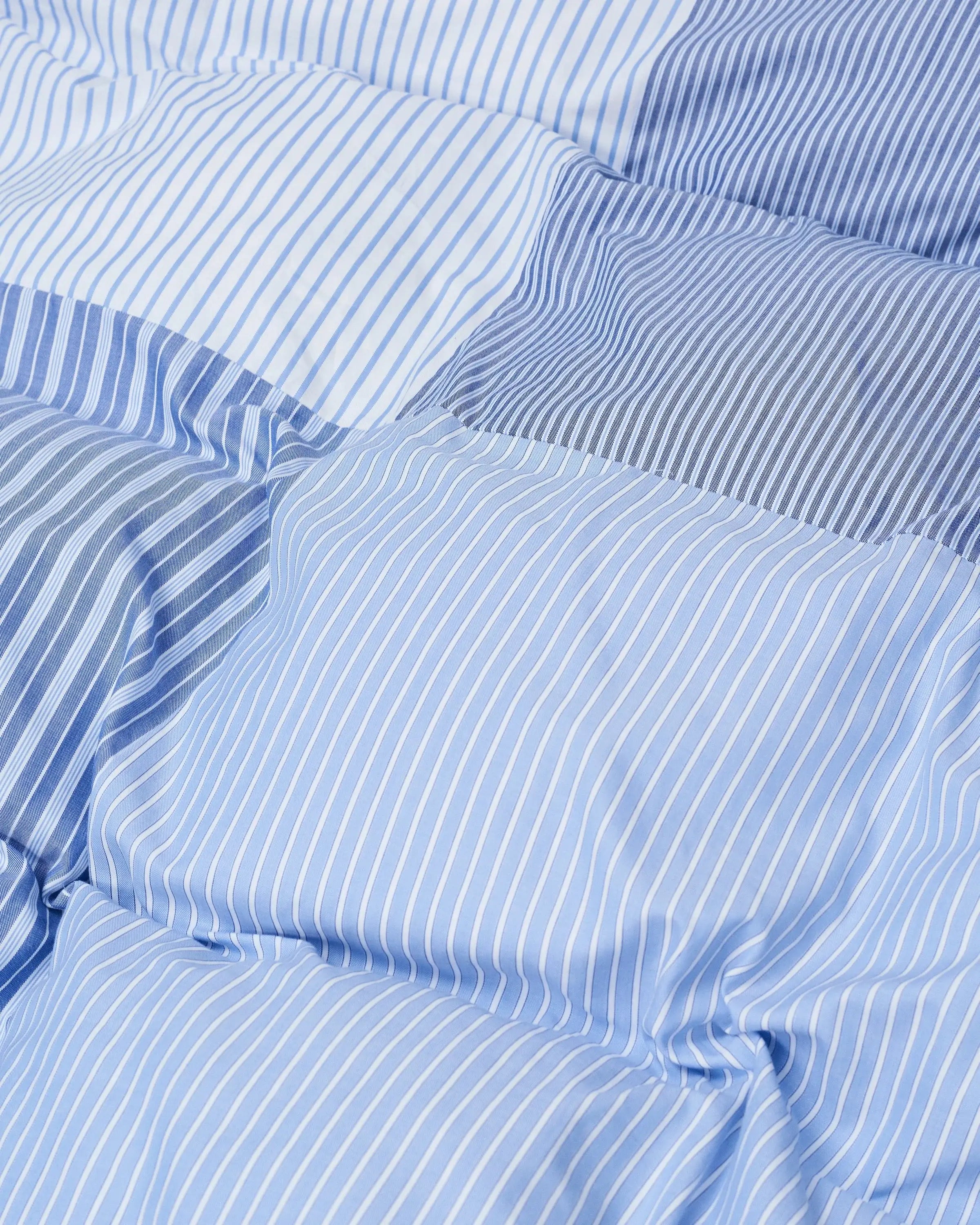Close up of the Magniberg patchwork duvet cover in various stripes