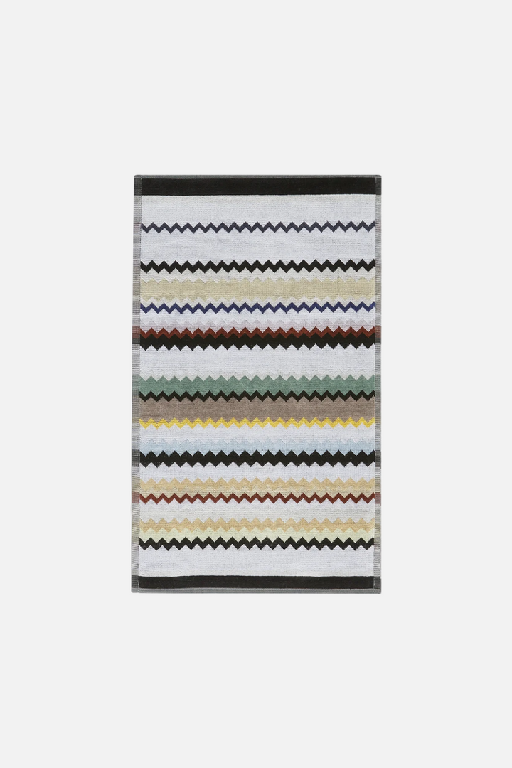 Striped hand towel with multi-coloured pattern on a white background