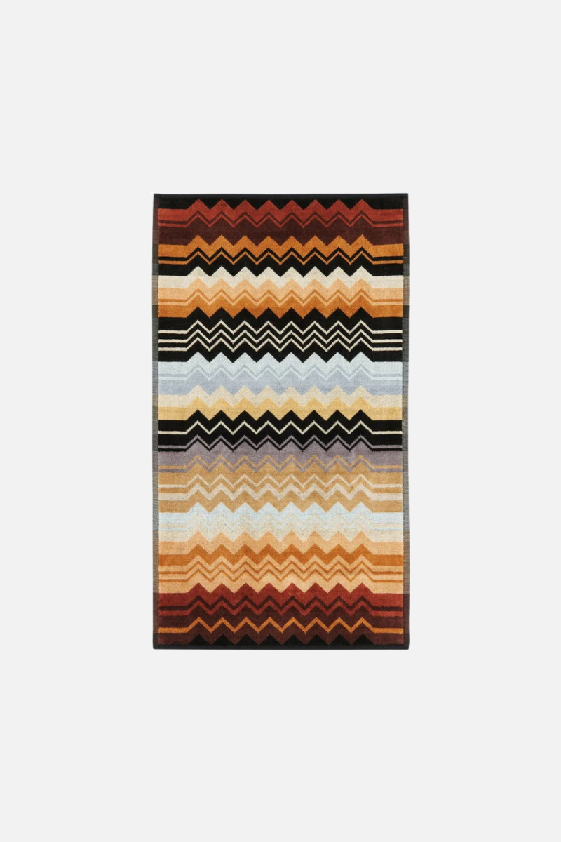 Colorful Giacomo 160 hand towel striped with zigzag pattern on a white background