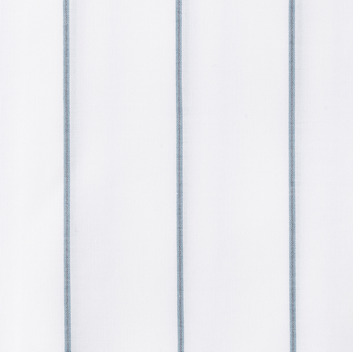 Close-up of Matouk Amalfi white fabric with subtle blue stripes.