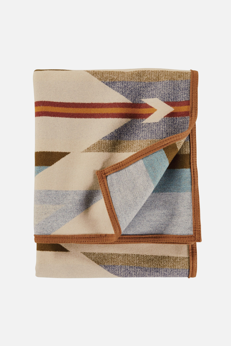 Folded blanket with geometric pattern on a white background