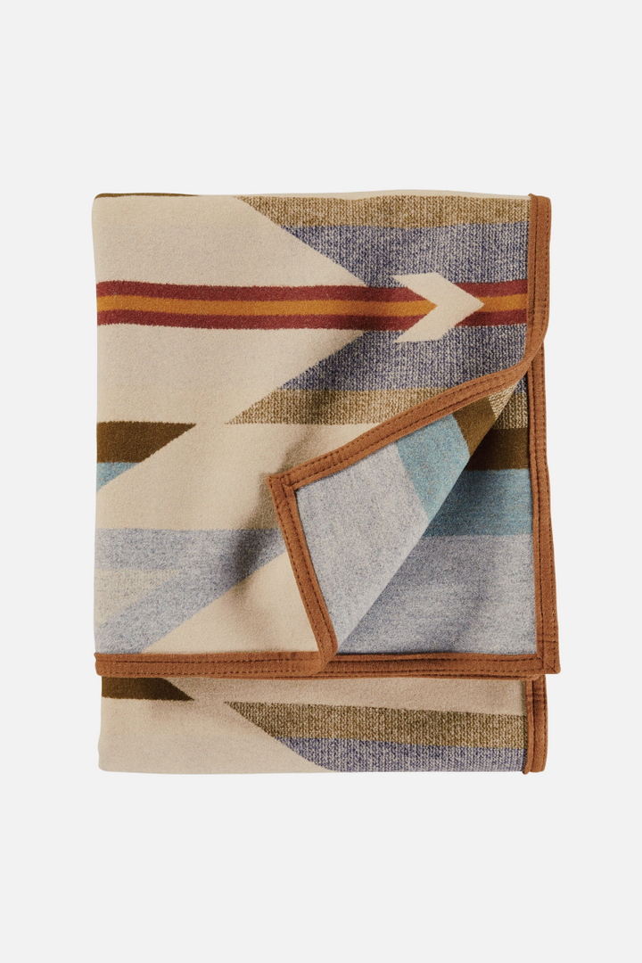 Folded blanket with geometric pattern on a white background