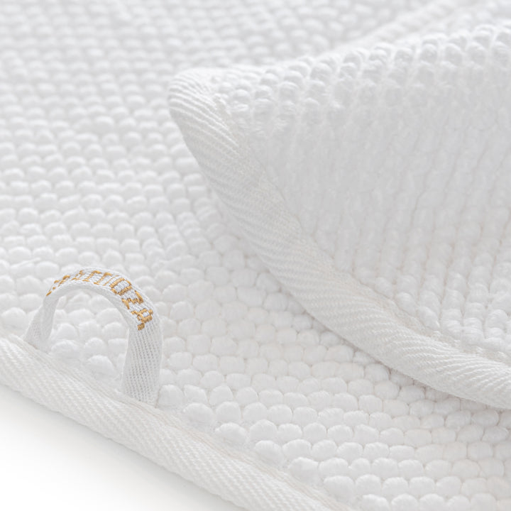 Graccioza Pearls White textured bath towel with a brand logo on a white background