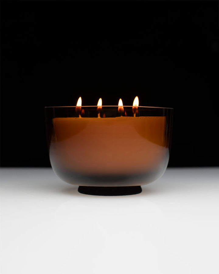 Serax Vincent van Duysen Candle in a transparent bowl with a black base on a white surface and black background