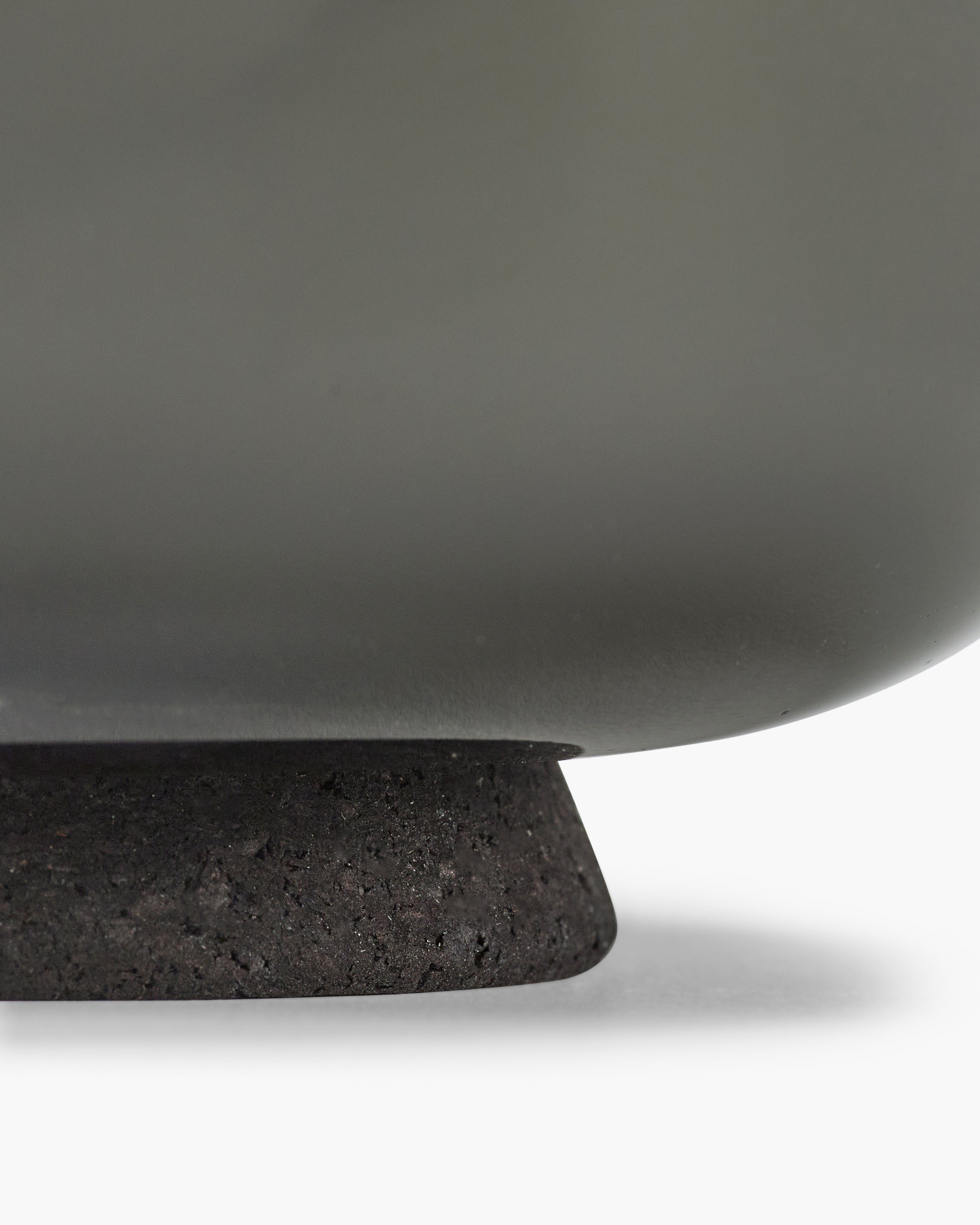 Close-up of a dark gray ceramic bowl with a textured base on a white background serax vincent van duysen