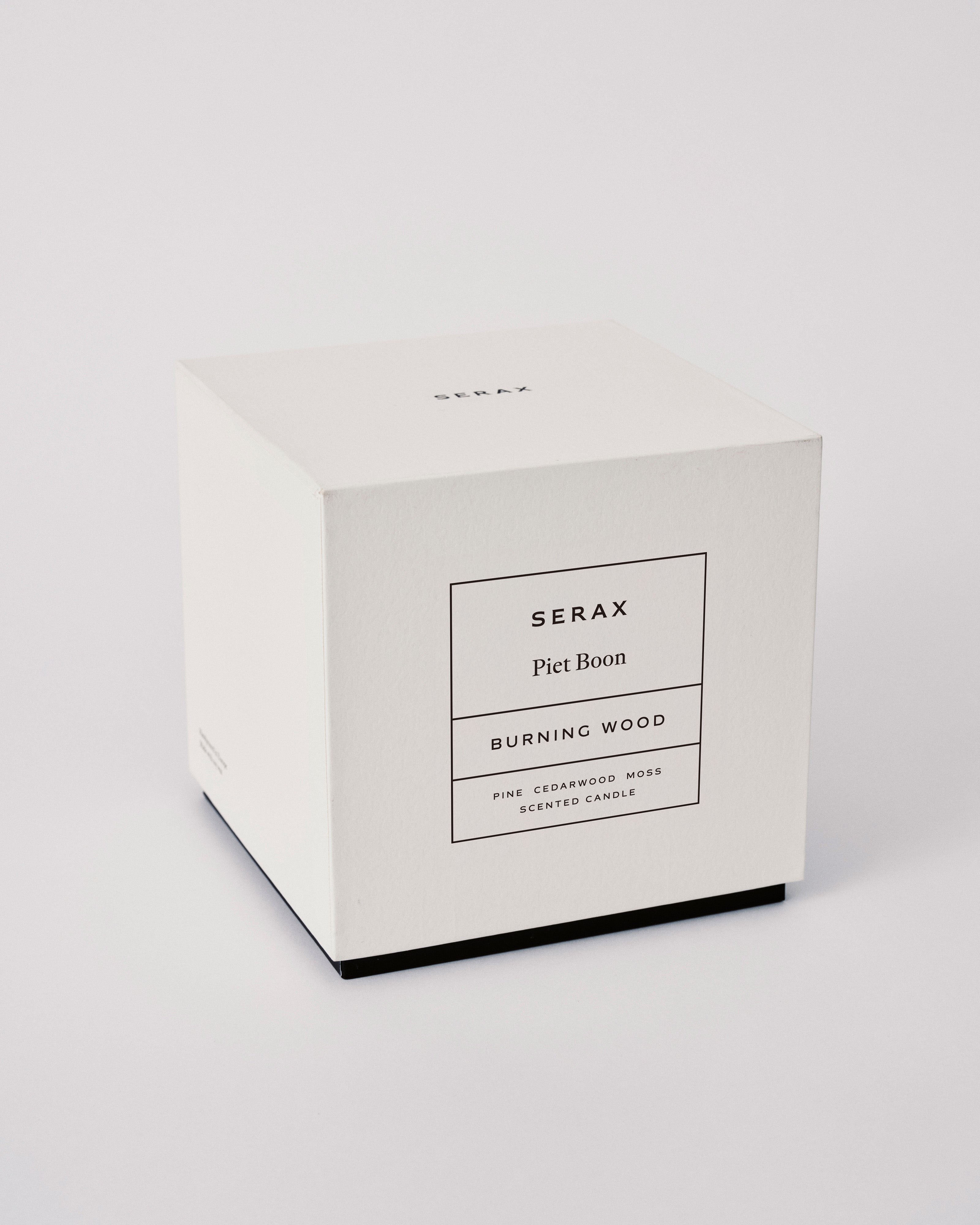 White candle box with 'Serax' branding on a light gray background