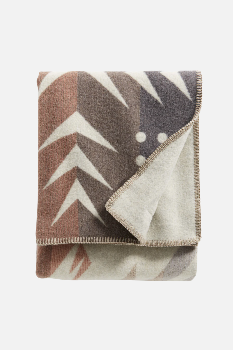 Folded blanket with geometric pattern on a white background