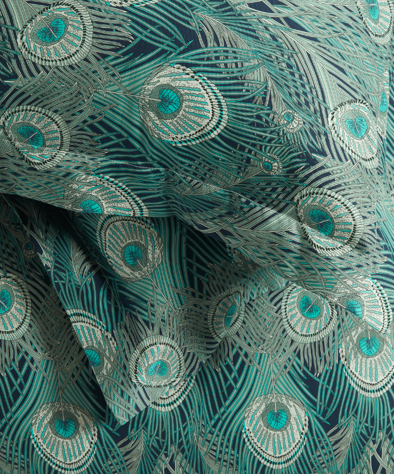Close up of the Liberty London Hera bedding with two pillowcases lying on top of each other atop a sheet. 